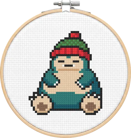 Christmas Snorlax cross-stitch pattern, stitched in a hoop